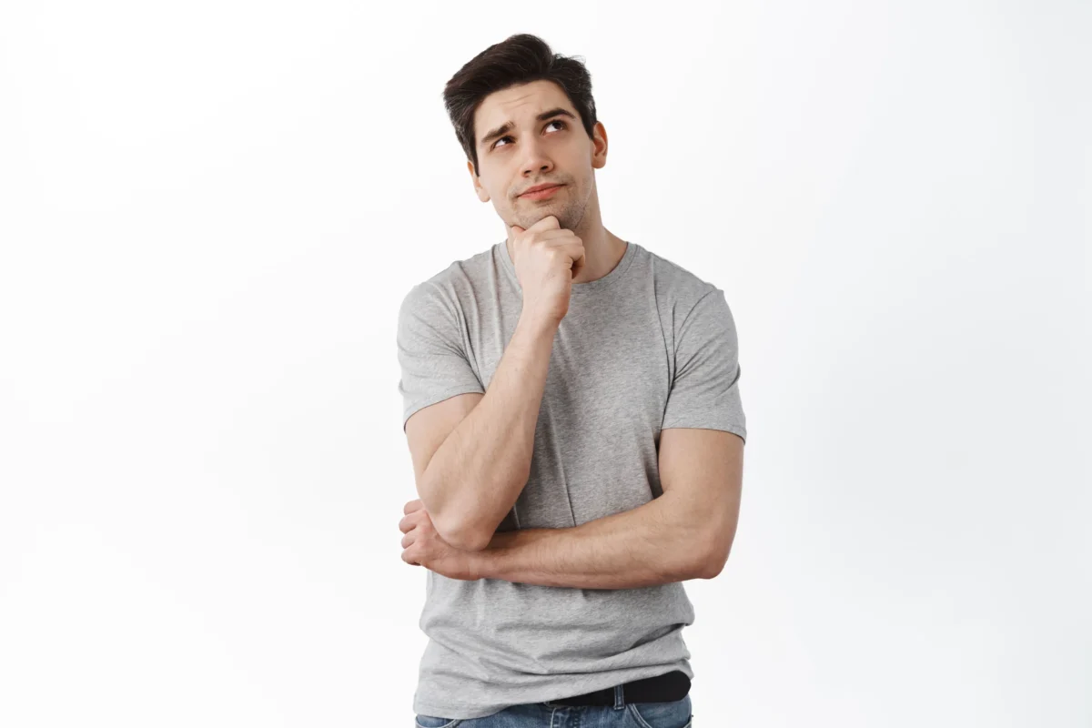 man deep thinking thoughts while holding chin